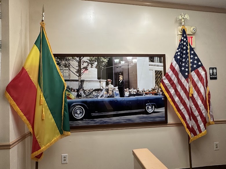 Ethiopian and American flags framing a historical photograph